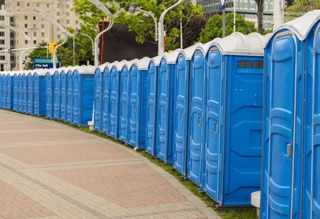 a row of portable restrooms set up for a large athletic event, allowing participants and spectators to easily take care of their needs in Hinckley OH